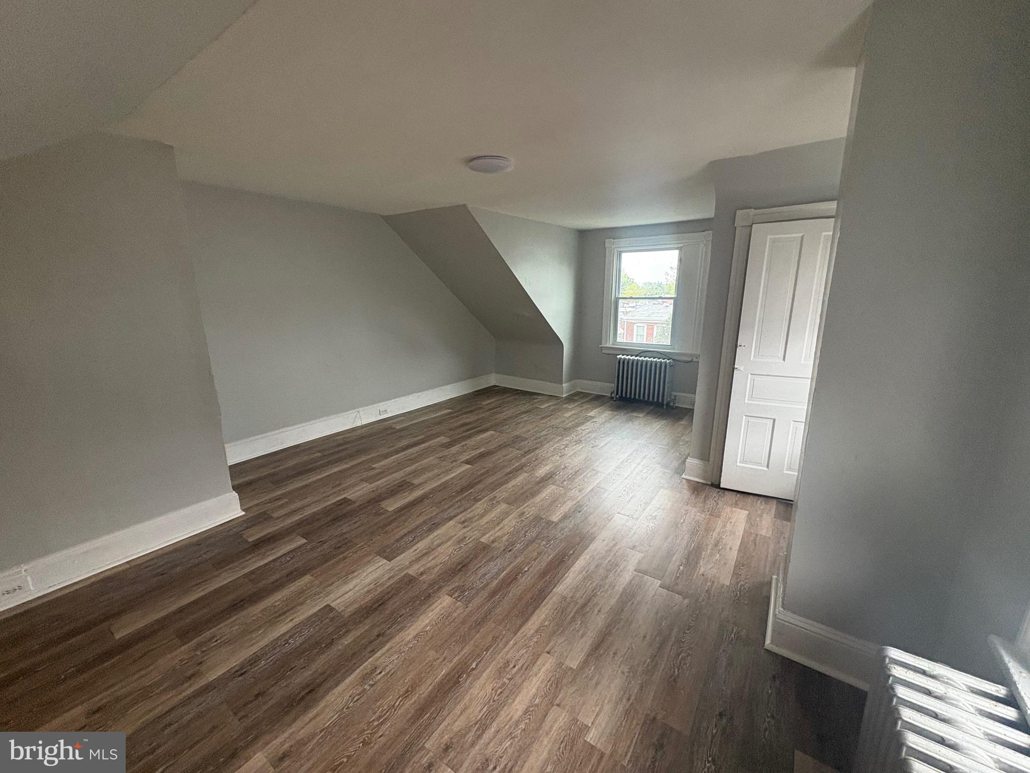 1337 71st Avenue, Unit 2 Philadelphia, PA 19126 - Photo 13 of 16 wooden floor in an empty room with a window