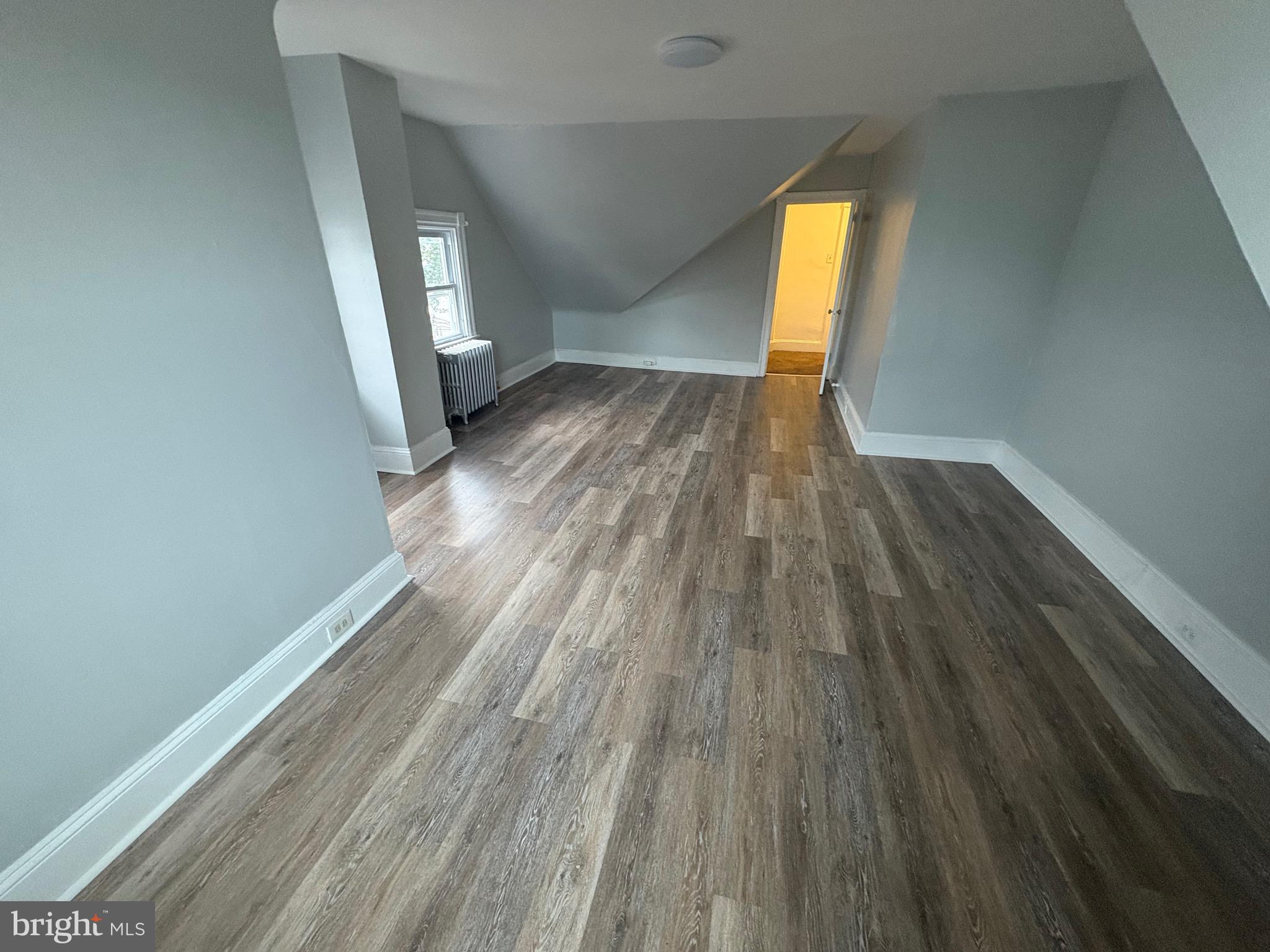 1337 71st Avenue, Unit 2 Philadelphia, PA 19126 - Photo 14 of 16 wooden floor in an empty room with a window