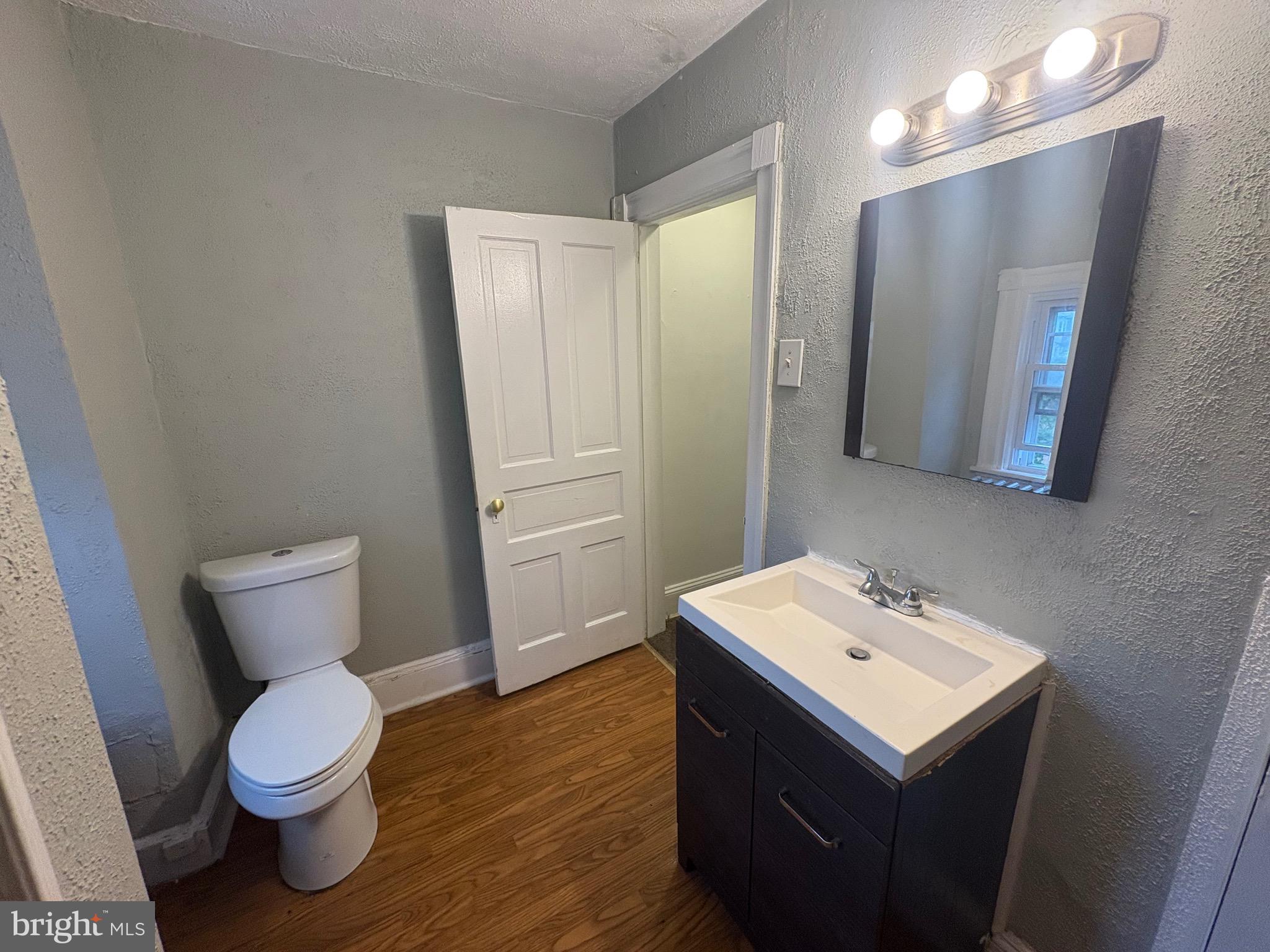 1337 71st Avenue, Unit 2 Philadelphia, PA 19126 - Photo 15 of 16 a bathroom with a toilet sink and mirror