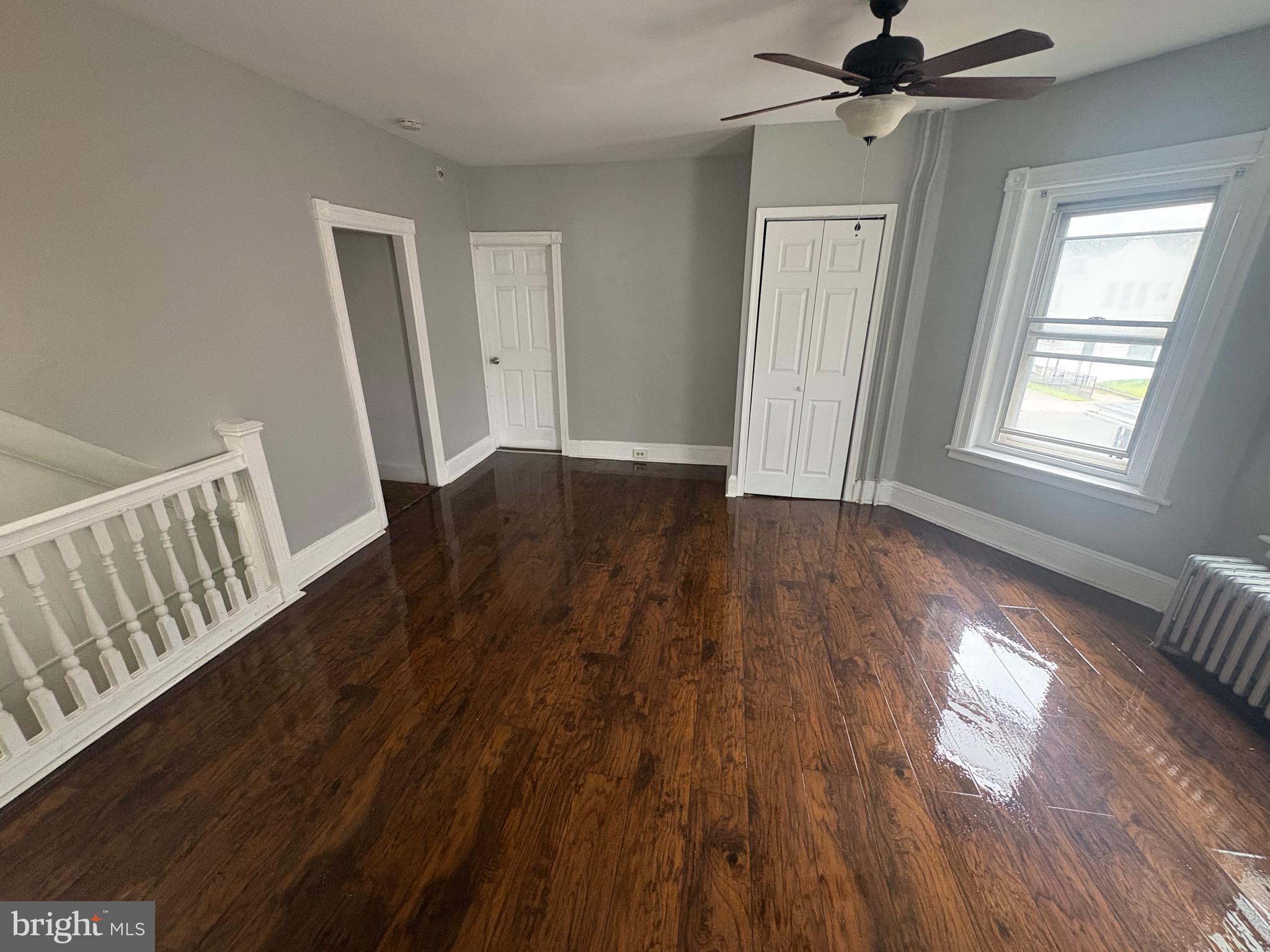 1337 71st Avenue, Unit 2 Philadelphia, PA 19126 - Photo 3 of 16 a view of an empty room with wooden floor and window