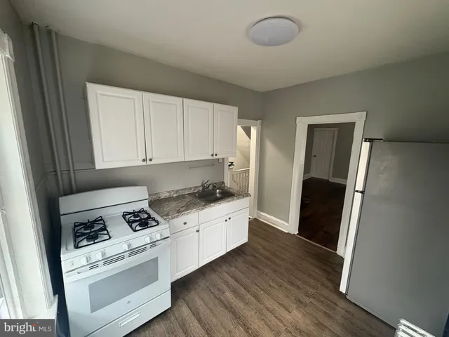 a kitchen with stainless steel appliances granite countertop a refrigerator stove and sink