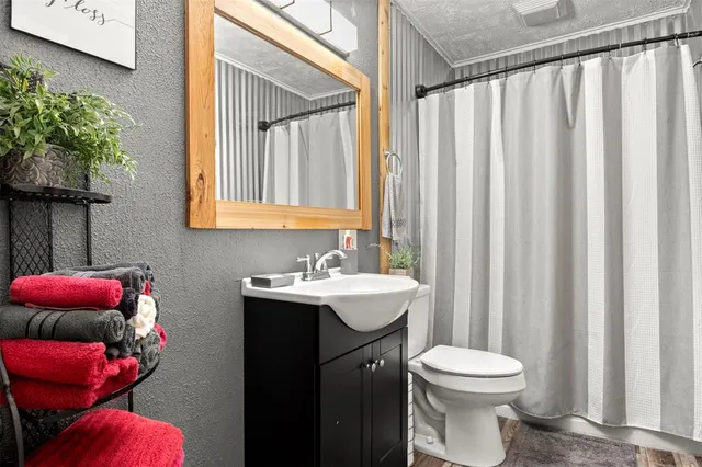 a bathroom with a toilet sink and mirror