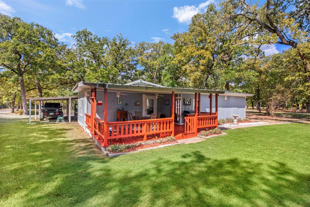 14802 North 3rd Street Scurry, TX 75158 - Photo 2 of 40 a view of a house with a yard porch and sitting area