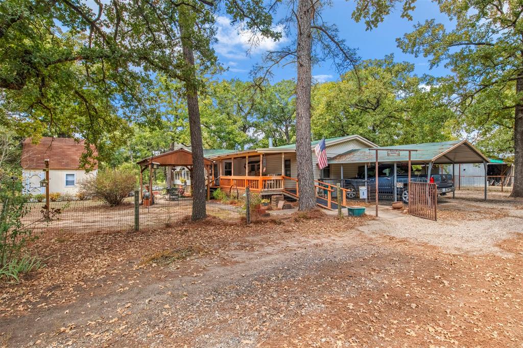 14802 North 3rd Street Scurry, TX 75158 - Photo 27 of 40 a view of house with a big yard and large trees