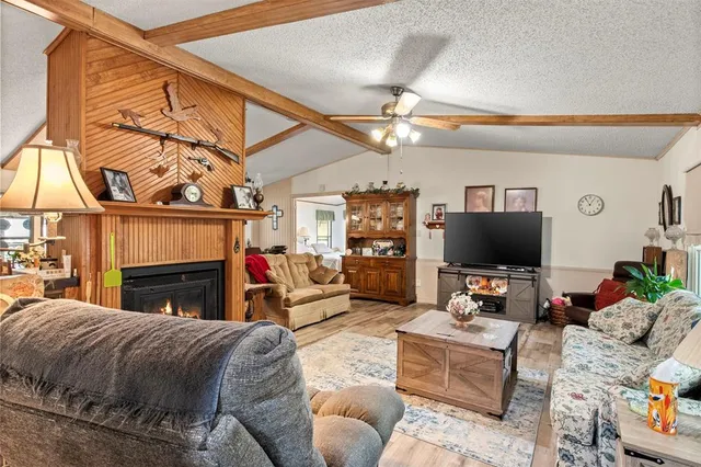 a living room with furniture a fireplace and a flat screen tv