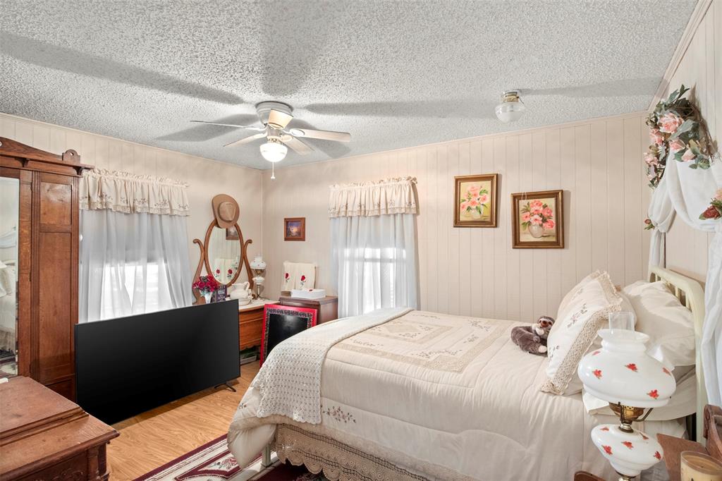 14802 North 3rd Street Scurry, TX 75158 - Photo 36 of 40 a bedroom with a bed and a large window with the outer view