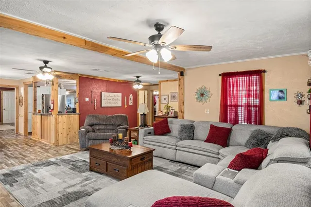 a living room with furniture ceiling fan and a rug