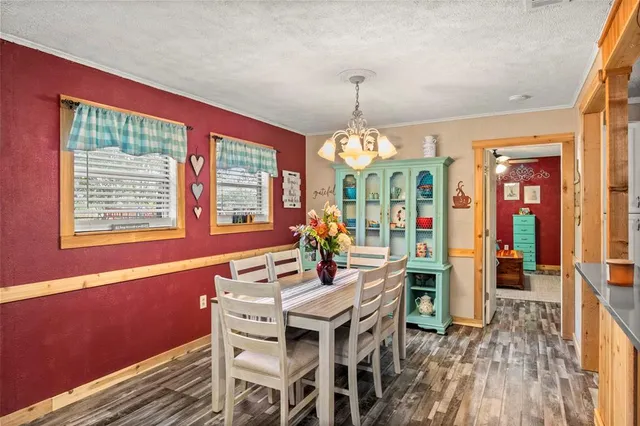 a view of a dining room with furniture wooden floor and chandelier
