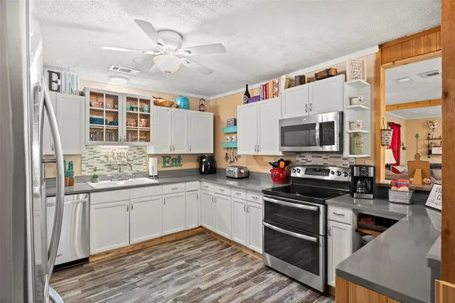 a kitchen with stainless steel appliances granite countertop a stove and a sink