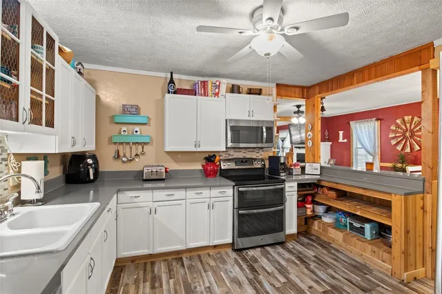 a kitchen with stainless steel appliances granite countertop a sink and cabinets