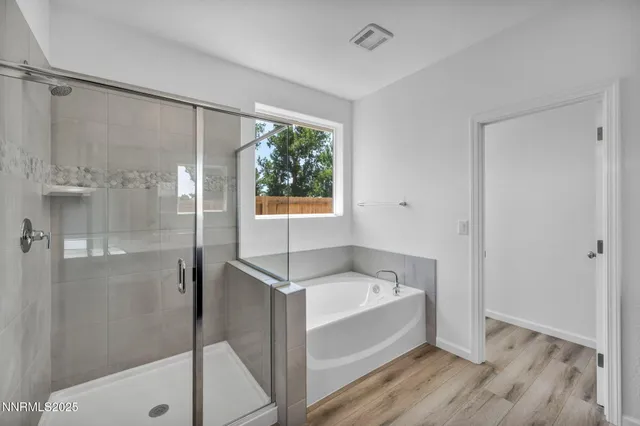 a bathroom with a bathtub and a shower