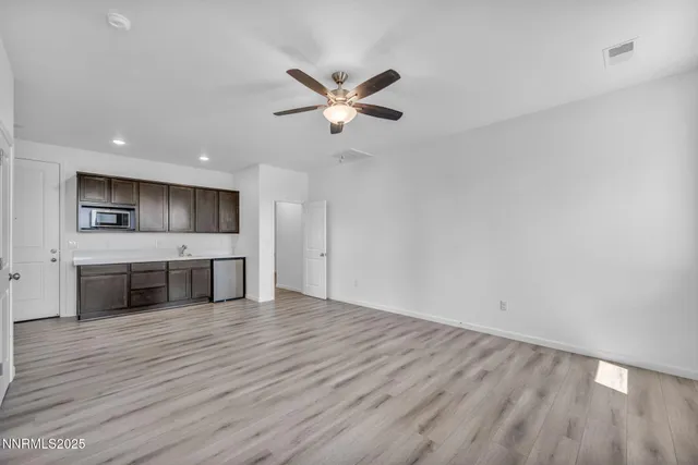 a view of a kitchen with a sink and wooden floor