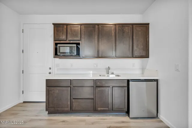 a kitchen with a sink cabinets and stainless steel appliances