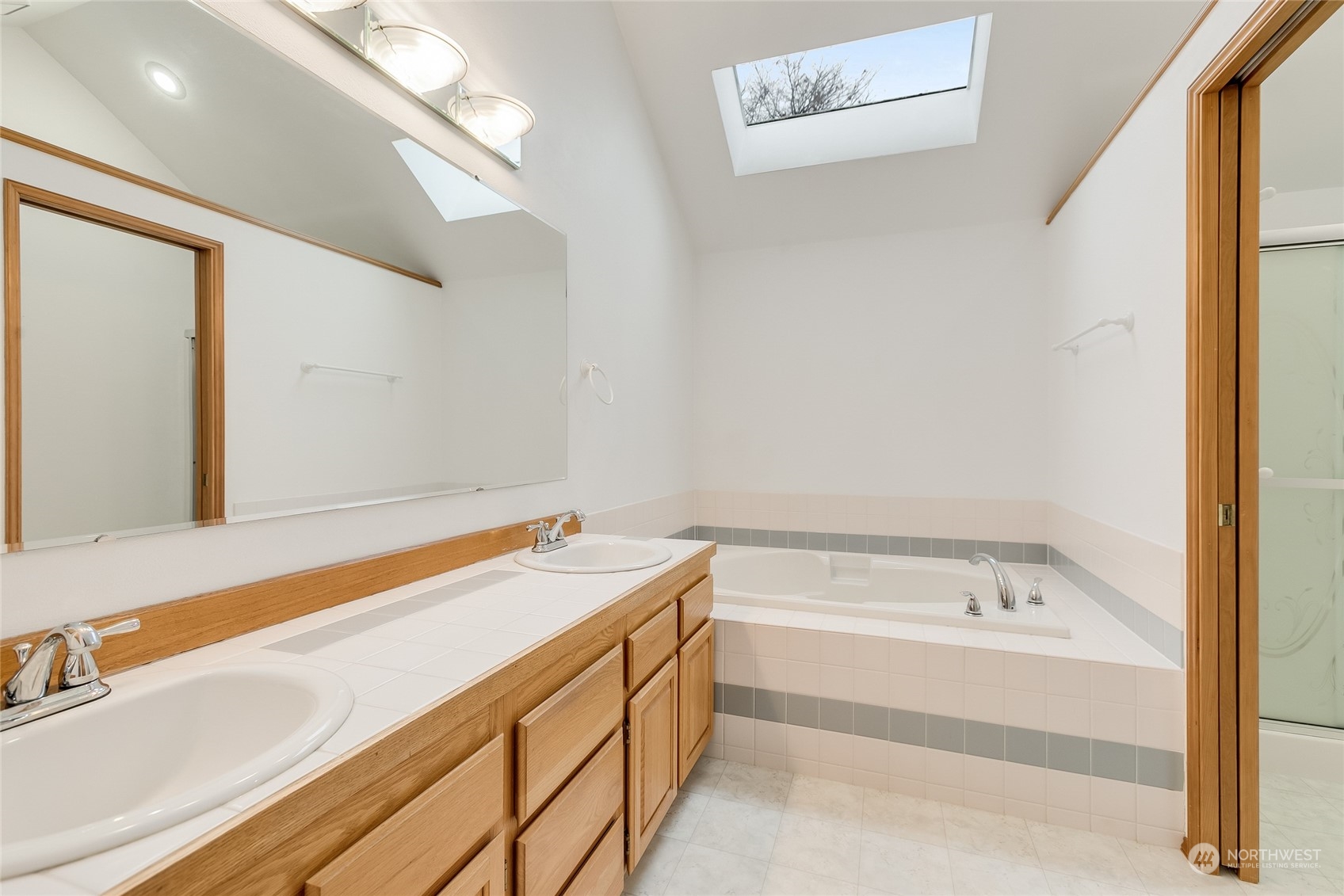2667 Southwest 343rd Street Federal Way, WA 98023 - Photo 13 of 24 a bathroom with a tub sink and mirror