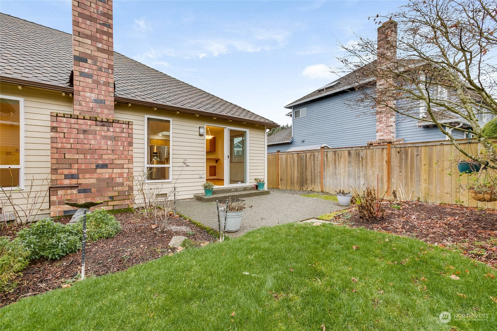 2667 Southwest 343rd Street Federal Way, WA 98023 - Photo 19 of 24 a view of a backyard with table and chairs and wooden fence