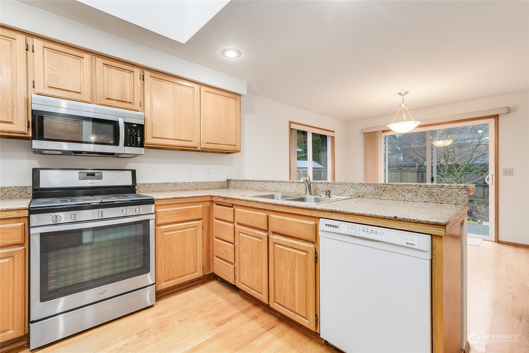 2667 Southwest 343rd Street Federal Way, WA 98023 - Photo 7 of 24 a kitchen with stainless steel appliances granite countertop a stove microwave and cabinets