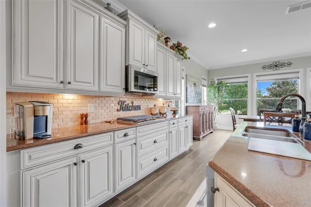 a kitchen with sink cabinets and living room