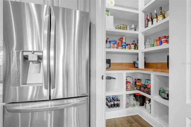 a dining room with furniture a potted plant and a chandelier