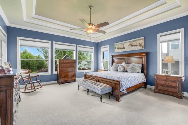 a bedroom with a bed and ceiling fan