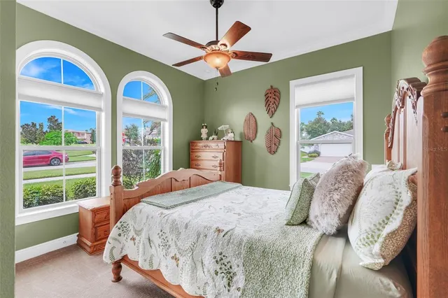 a bedroom with a bed and a large window