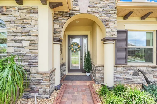 a view of a brick house with potted plants