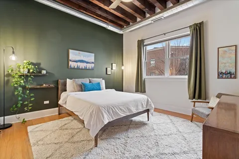 a bedroom with a bed and a potted plant