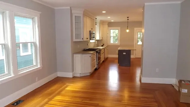 a view of a kitchen with kitchen island wooden floors wooden floor and center island