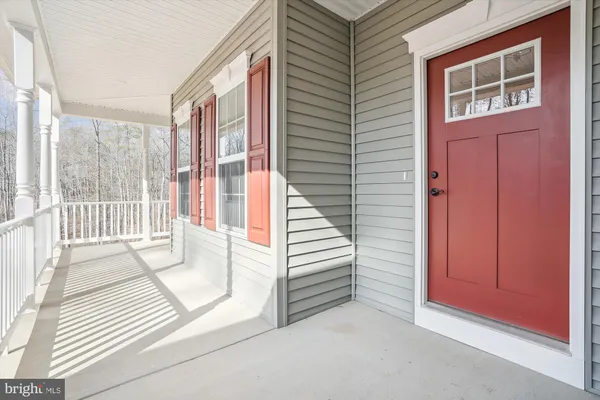a view of a house with a floor to ceiling window and wooden floor