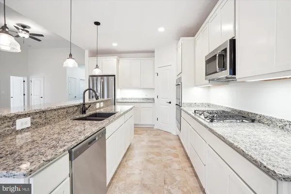 a kitchen with a sink stove and microwave