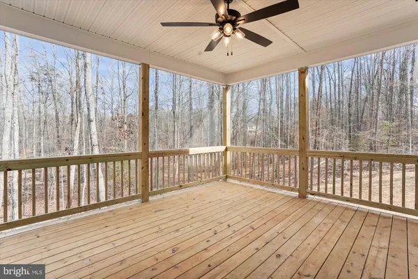 a view of a porch with wooden floor and outdoor space