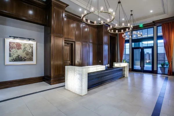 a lobby with furniture and a chandelier