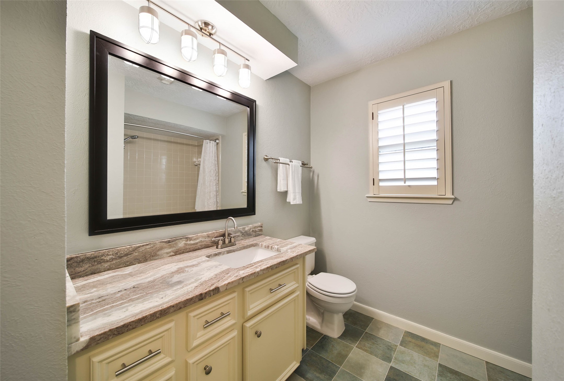 17007 Windrow Drive Spring, TX 77379 - Photo 36 of 46 a bathroom with a granite countertop toilet a sink and a mirror