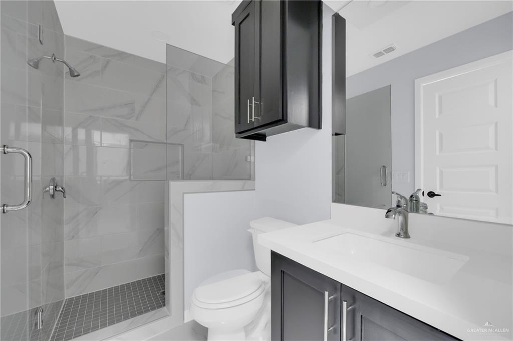 1620 Shadow Creek Drive, Unit 4 Weslaco, TX 78596 - Photo 11 of 12 a bathroom with a sink toilet and shower