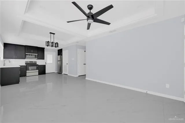 a view of a kitchen with a sink and dishwasher a refrigerator with wooden floor