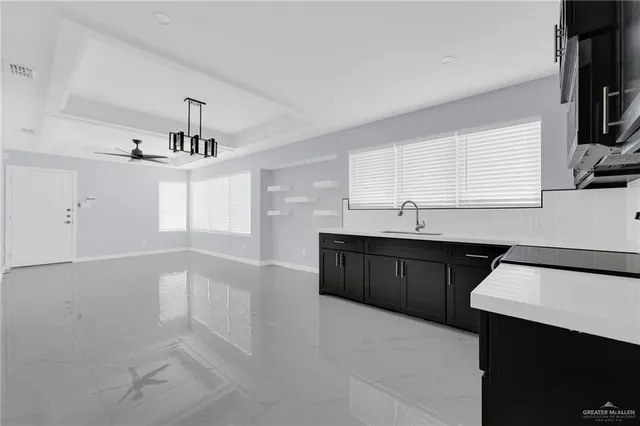 a kitchen with a sink a window and cabinets
