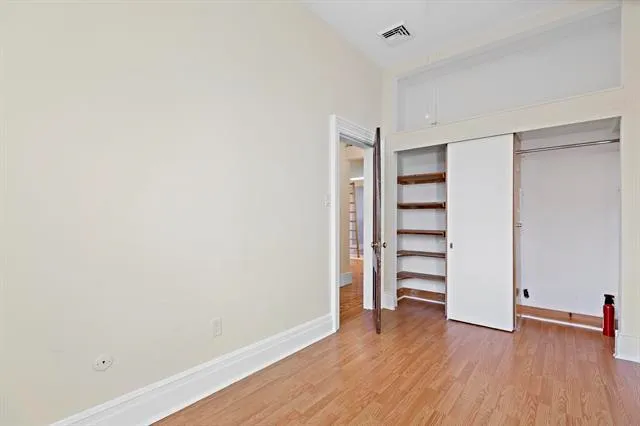 a view of walk in closet with empty racks