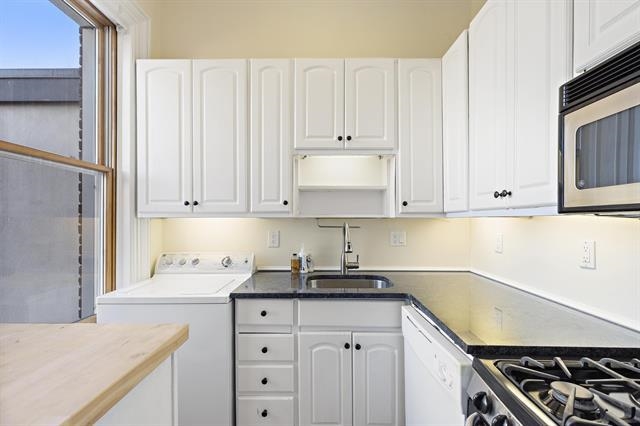 910 Hudson Street, Unit 3 Hoboken, NJ 07030 - Photo 4 of 14 a kitchen with granite countertop white cabinets and stainless steel appliances
