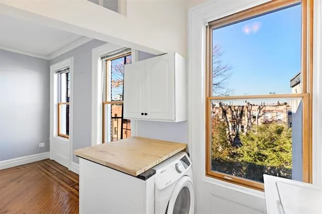 a view of a kitchen with a fridge and a window