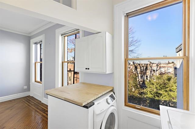 910 Hudson Street, Unit 3 Hoboken, NJ 07030 - Photo 5 of 14 a view of a kitchen with a fridge and a window
