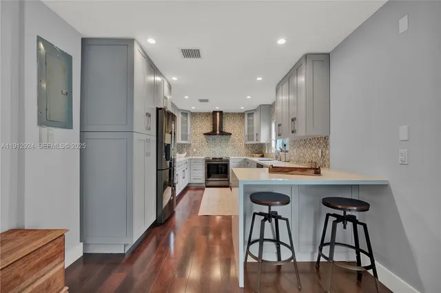 a kitchen with a table chairs refrigerator and cabinets