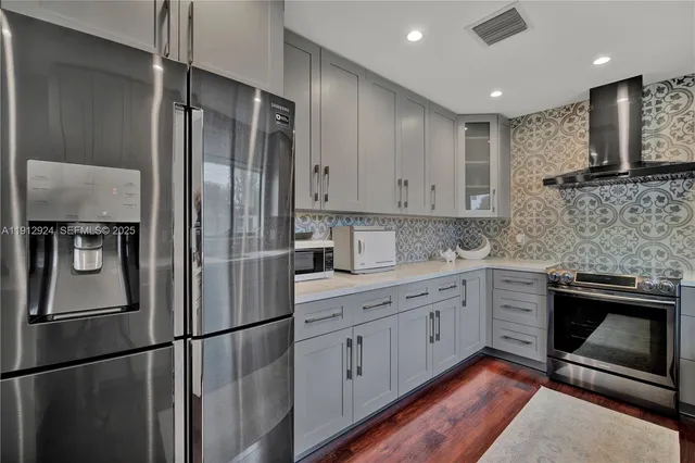 a kitchen with a refrigerator sink and cabinets