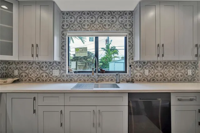a sink with a granite countertop window