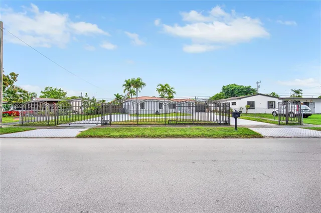 an aerial view of a house with garden space and street view