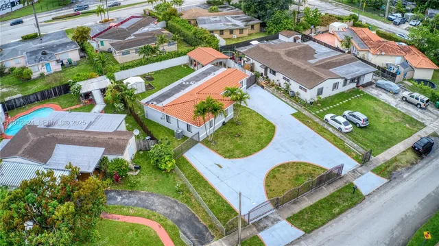 an aerial view of a house with outdoor space and a lake view