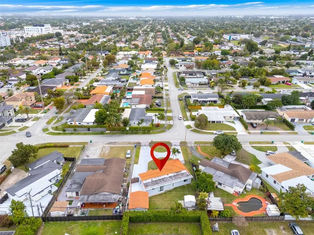 an aerial view of residential houses with outdoor space