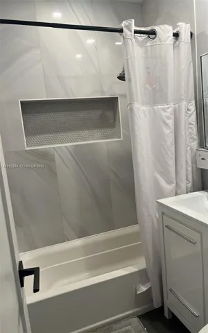 a bathroom with a shower and a sink