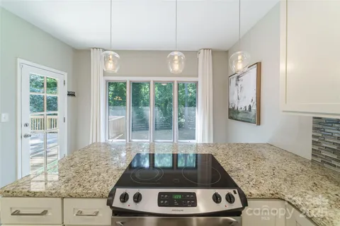 a living room with hard wood floor and a floor to ceiling window