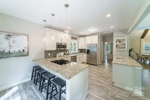 a large kitchen with a table and chairs