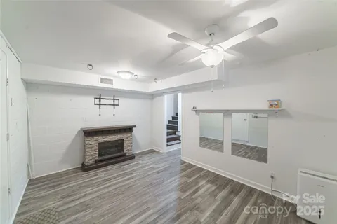 an empty room with wooden floor and fireplace