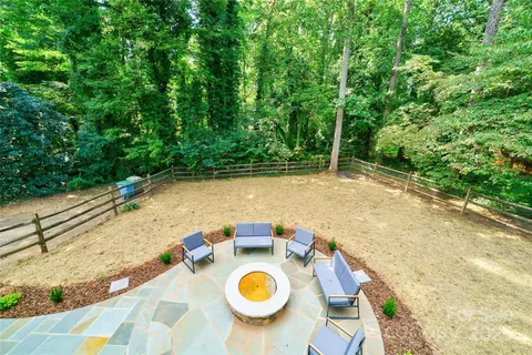 a view of backyard with swimming pool and seating space